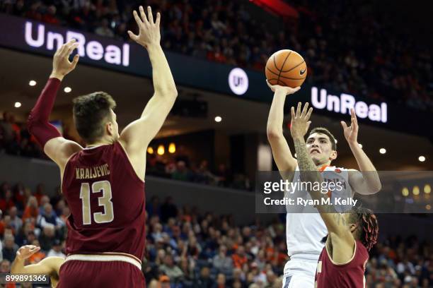 Ty Jerome of the Virginia Cavaliers shoots over Ky Bowman and Luka Kraljevic of the Boston College Eagles in the second half during a game at John...