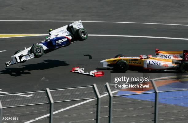 Nick Heidfeld of Germany and BMW Sauber collides with Fernando Alonso of Spain and Renault during practice for the European Formula One Grand Prix at...