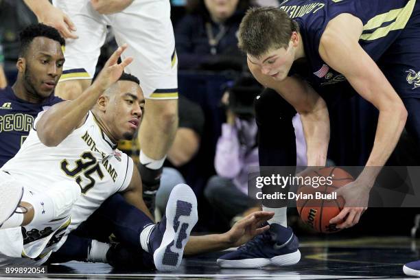 Bonzie Colson of the Notre Dame Fighting Irish battles for a loose ball against Josh Okogie and Ben Lammers of the Georgia Tech Yellow Jackets in the...