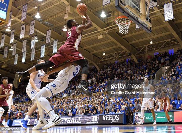 Wendell Carter Jr of the Duke Blue Devils draaws a charging foul against Trent Forrest of the Florida State Seminoles during the closing minute of...