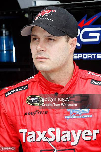 David Gilliland, driver of the Tax Slayer Chevrolet, stands in his pit prior to practice for the NASCAR Sprint Cup Series Sharpie 500 at Bristol...