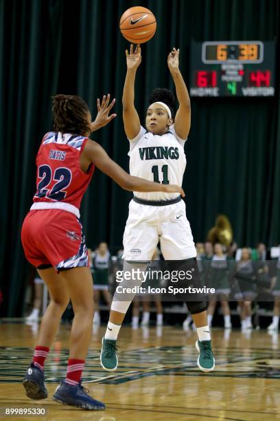 Cleveland State Vikings guard Khayla Livingston shoots over Detroit Titans guard/forward Zoey Oatis during the fourth quarter of the women's college...