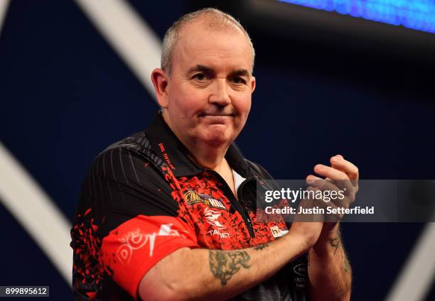 Phil Taylor celebrates after winning his Semi Final Match against Jamie Lewis during the 2018 William Hill PDC World Darts Championships at Alexandra...
