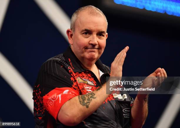 Phil Taylor celebrates after winning his Semi Final Match against Jamie Lewis during the 2018 William Hill PDC World Darts Championships at Alexandra...