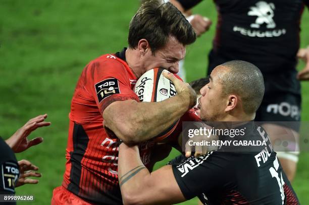 Toulon's winger Vincent Clerc collides with Toulouse's Gael Fickou during the French Top 14 rugby union match between Toulouse and Toulon, at...