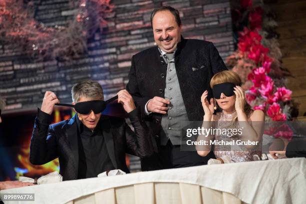 Chef Johann Lafer and hosts Joerg Pilawa and Francine Jordi are seen on stage during the New Year's Eve tv show hosted by Joerg Pilawa on December...