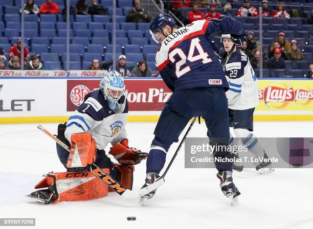 Ukko-Pekka Luukkonen of Finland makes a pad save on a tipped shot by Vojtech Zelenak of Slovakia during the first period of play in the IIHF World...