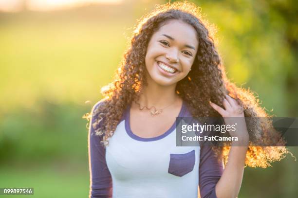 teenage girl outdoors - 14 year old biracial girl curly hair stock pictures, royalty-free photos & images