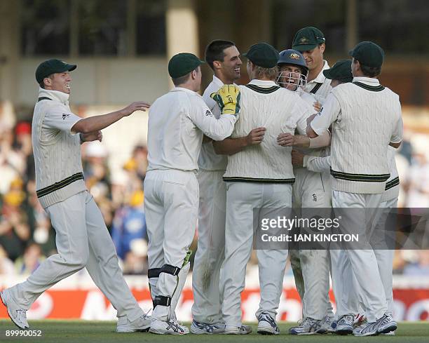 Australia's Mitchell Johnson celebrates the wicket of England's Paul Collingwood caught by Australia's Simon Katich on the second day of the fifth...