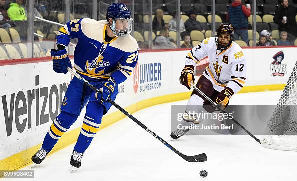 Steven Ruggiero of the Lake Superior Lakers skates with the puck ...