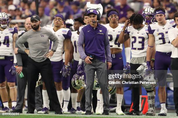 Head coach Chris Petersen of the Washington Huskies walks down the sidelines during the first half of the Playstation Fiesta Bowl against the Penn...