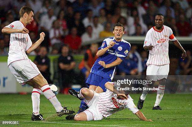 Marcel Schied of Rostock battles for the ball with Christian Stuff, Daniel Goehlert and Younga Mouhani of Berlin during the Second Bundesliga match...