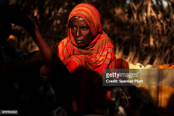 Woman fills a bucket with water August 21, 2009 in Dadaab, the world�s biggest refugee complex in Dadaab, Kenya. The Dadaab refugee complex in...