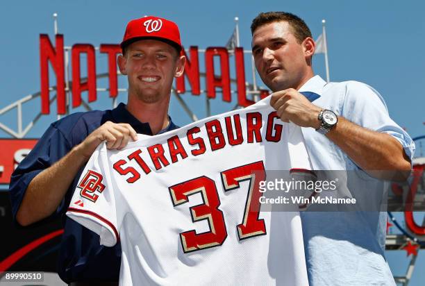 Stephen Strasburg , the overall first pick in the 2009 MLB Draft, is presented with his jersey by Nationals third baseman Ryan Zimmerman after being...
