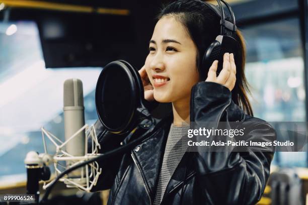 asian girl singing at a recording studio,shanghai,china - condenser microphone stock pictures, royalty-free photos & images