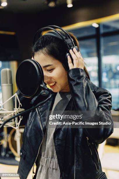 asian girl singing at a recording studio,shanghai,china - condenser microphone stock pictures, royalty-free photos & images