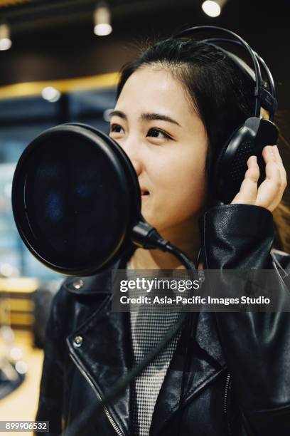 asian girl singing at a recording studio,shanghai,china - condenser microphone stock pictures, royalty-free photos & images