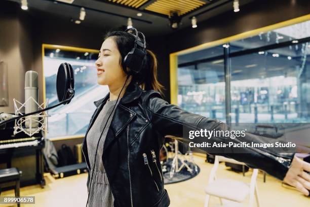 asian girl singing at a recording studio,shanghai,china - condenser microphone stock pictures, royalty-free photos & images