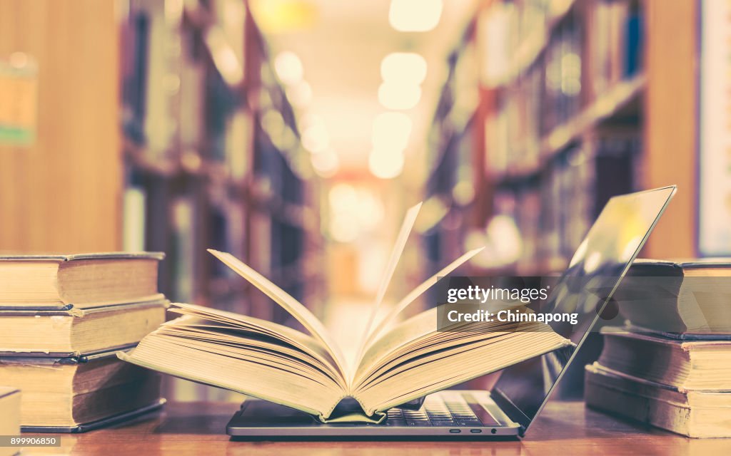 Computer Between Books Book And Computer Technology In Library High-Res Stock Photo - Getty Images