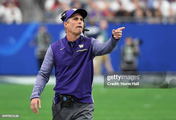 Head coach Chris Petersen of the Washington Huskies points to the endzone from the sidelines during a game against the Penn State Nittany Lions...
