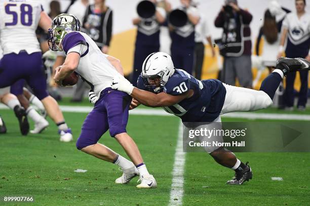 Kevin Givens of the Penn State Nittany Lions grabs ahold of Jake Browning of the Washington Huskies during the first half of the Playstation Fiesta...