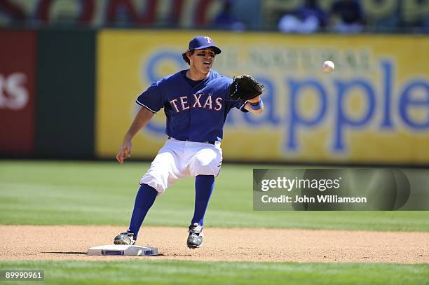 Second baseman Ian Kinsler of the Texas Rangers fields his position as he catches a throw at second base for the first out of a double play during...