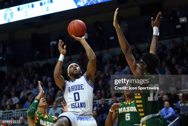 Rhode Island Rams guard E.C. Matthews shoots over George Mason Patriots guard Jaire Grayer and George Mason Patriots forward AJ Wilson during a...