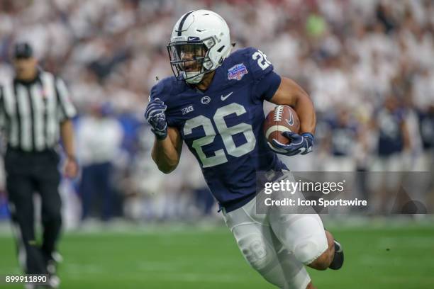 Saquon Barkley of the Penn State Nittany Lions runs for a gain in the game between the Washington Huskies and the Penn State Nittany Lions on...