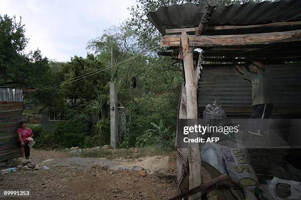 Martha , sister of Mexican Alejandro Vargas , looks at the hut where he remains chained in Jalpan de Serra, Queretaro state, Mexico on July 28, 2009....