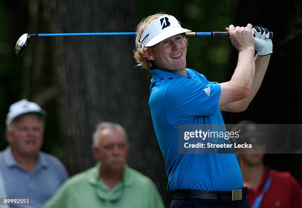 Brandt Snedeker watches his tee shot on during the second round of the Wyndham Championship at Sedgefield Country Club on August 21, 2009 in...