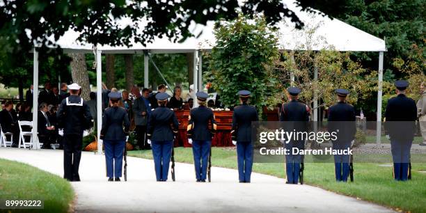 Members of the Military stand at attention during the funeral of music legend Les Paul at the burial grounds for the private family funeral at the...