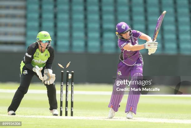 Lauren Winfield of the Hurricanes is bowled by Rene Farrell of the Thunder during the Women's Big Bash League match between the Sydney Thunder and...