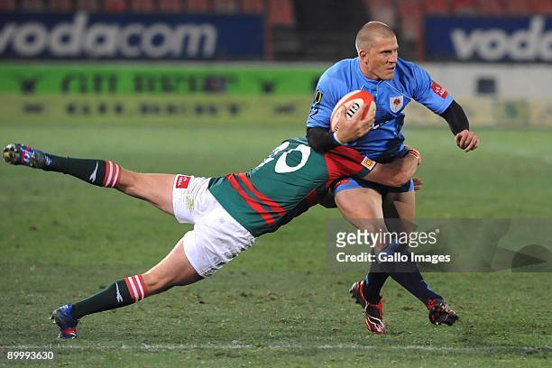 Jaco Pretorius of the Bulls is tackled by Michael Bondesio of the Leopards during the Absa Currie Cup match between Blue Bulls and Leopards at Loftus...