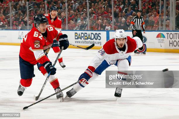 Denis Malgin of the Florida Panthers shoots the puck against Phillip Danault of the Montreal Canadiens at the BB&T Center on December 30, 2017 in...