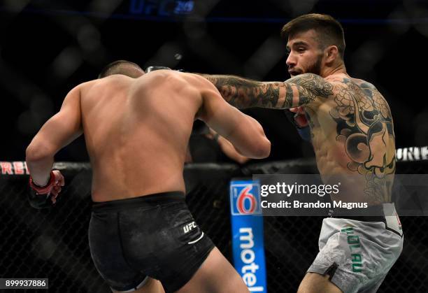 Matheus Nicolau of Brazil punches Louis Smolka in their flyweight bout during the UFC 219 event inside T-Mobile Arena on December 30, 2017 in Las...
