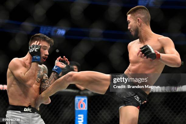 Louis Smolka kicks Matheus Nicolau of Brazil in their flyweight bout during the UFC 219 event inside T-Mobile Arena on December 30, 2017 in Las...