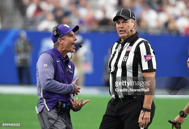Head coach Chris Petersen of the Washington Huskies argues a call with headlinesman Al Green during a game against the Penn State Nittany Lions...