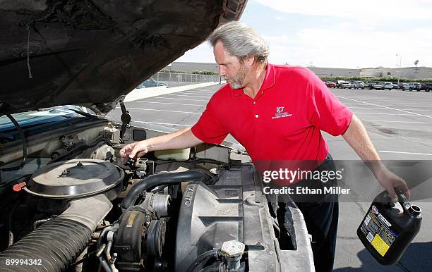 United Suzuki Mitsubishi service manager Kevin Blackwell uses a sodium silicate solution to kill the engine of a 1993 Chevrolet Silverado 1500 pickup...