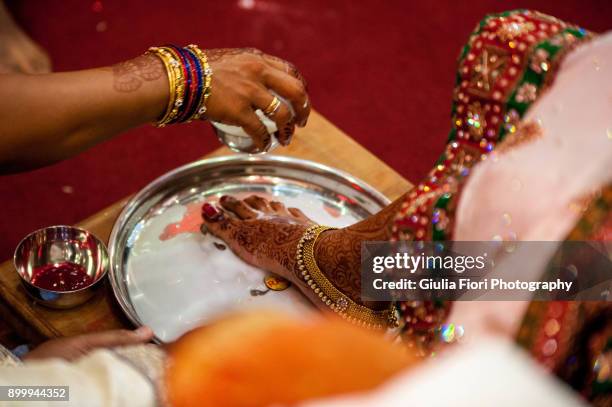 feet washing during a wedding ceremony - bridal bangles stock pictures, royalty-free photos & images