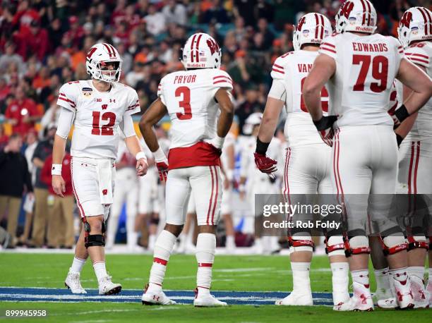 Alex Hornibrook of the Wisconsin Badgers walks to the huddle during the first quarter the 2017 Capital One Orange Bowl against the Miami Hurricanes...
