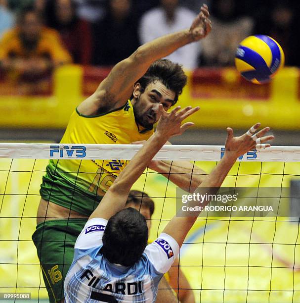 Brazil's Giba spikes the ball against Argentina`s Javier Filardi during their South American Final men's volleyball match in Bogota on August 21,...