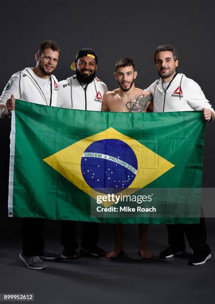 Matheus Nicolau of Brazil poses for a portrait backstage with his team after his victory over Louis Smolka during the UFC 219 event inside T-Mobile...