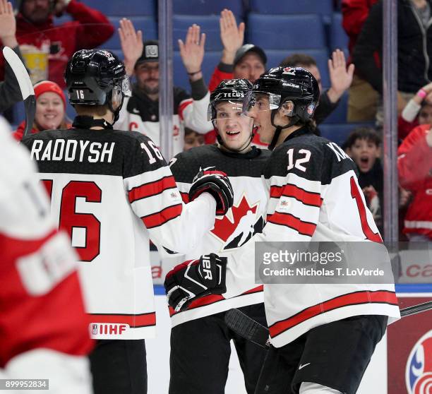 Robert Thomas of Canada celebrates the games opening goal with Taylor Raddysh and Boris Katchouk during the first period of play in the IIHF World...