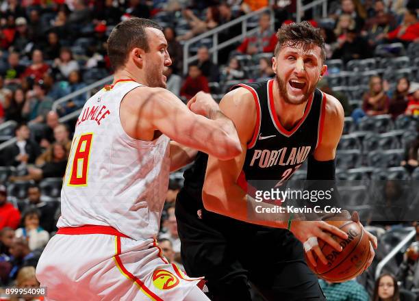 Jusuf Nurkic of the Portland Trail Blazers drives against Miles Plumlee of the Atlanta Hawks at Philips Arena on December 30, 2017 in Atlanta,...