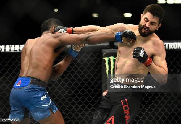 Neil Magny punches Carlos Condit in their welterweight bout during the UFC 219 event inside T-Mobile Arena on December 30, 2017 in Las Vegas, Nevada.