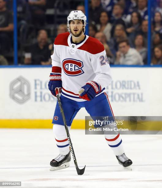 Phillip Danault of the Montreal Canadiens defends against the Tampa Bay Lightning during the first period at Amalie Arena on December 28, 2017 in...