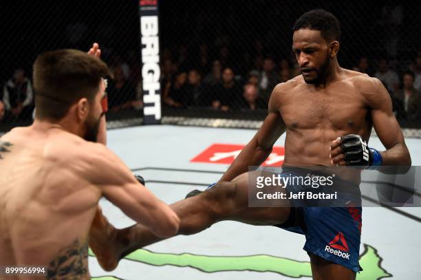 Neil Magny kicks Carlos Condit in their welterweight bout during the UFC 219 event inside T-Mobile Arena on December 30, 2017 in Las Vegas, Nevada.