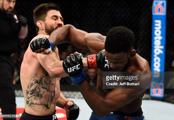 Carlos Condit punches Neil Magny in their welterweight bout during the UFC 219 event inside T-Mobile Arena on December 30, 2017 in Las Vegas, Nevada.