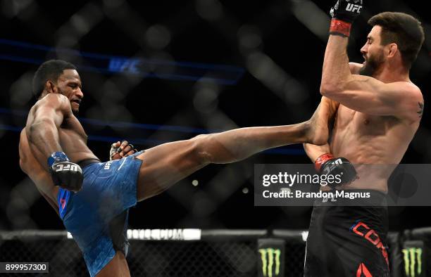 Neil Magny kicks Carlos Condit in their welterweight bout during the UFC 219 event inside T-Mobile Arena on December 30, 2017 in Las Vegas, Nevada.