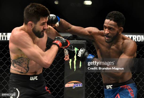 Neil Magny punches Carlos Condit in their welterweight bout during the UFC 219 event inside T-Mobile Arena on December 30, 2017 in Las Vegas, Nevada.